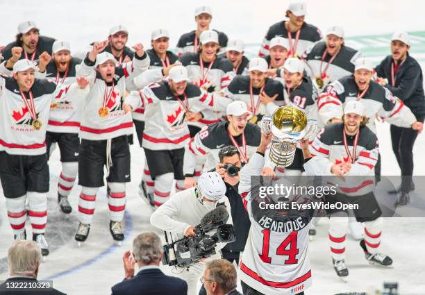 Adam Henrique of Canada holds up the trophy in front of teammates during the 2021 IIHF Ice Hockey World Championship Gold Medal Game game between...