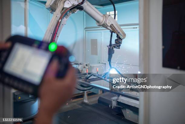 command automatic robot in metal manufacturing factory. - robotic welding stock pictures, royalty-free photos & images