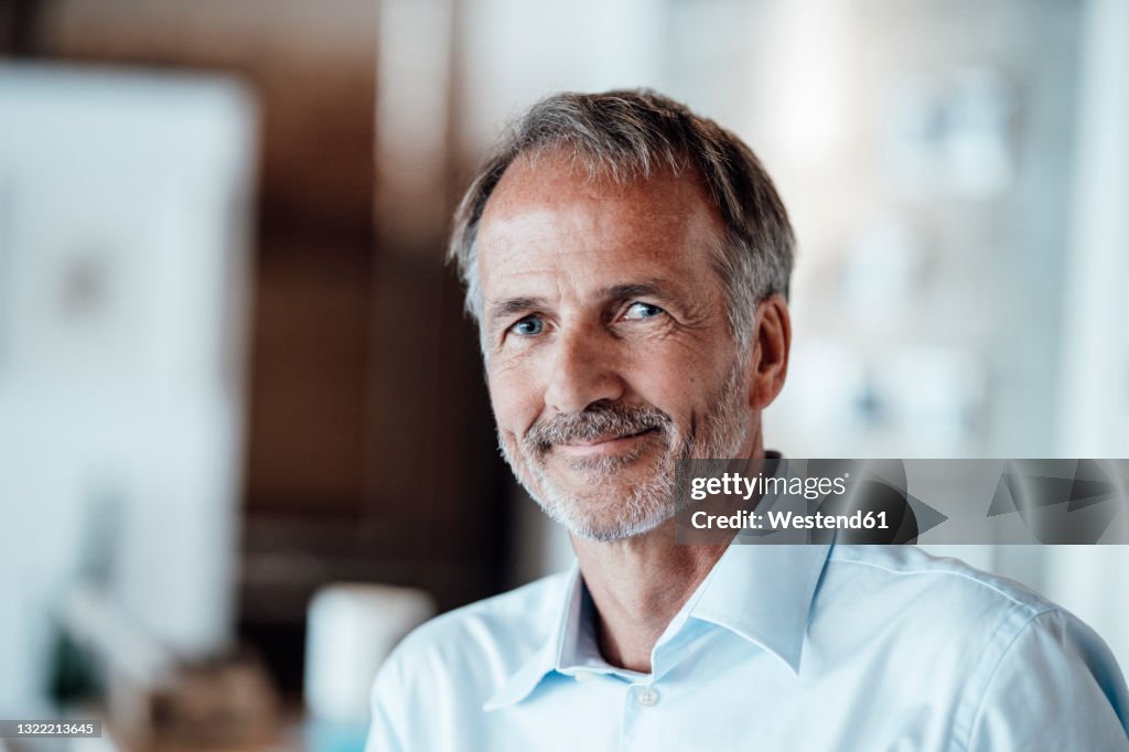 Senior businessman smiling in office