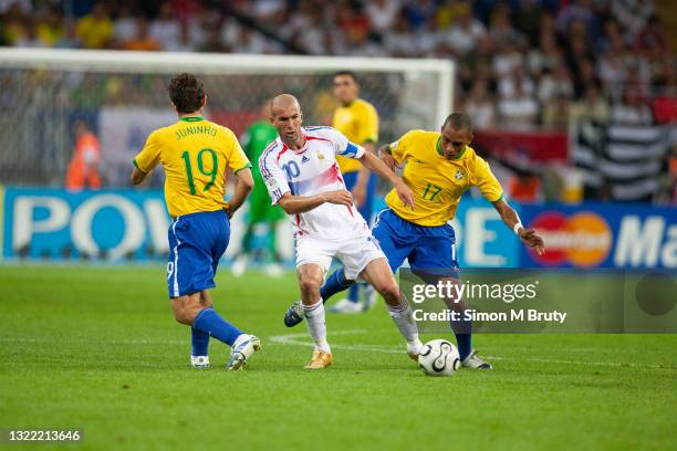 Zinedine Zidane of France and Gilberto Silva and Juninho Pernambucano of Brazil in action during the World Cup Quarter Final match between France and...