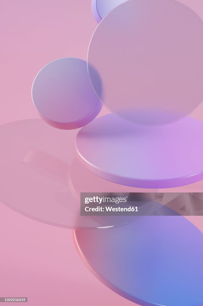 Three dimensional render of purple rings floating against pink background