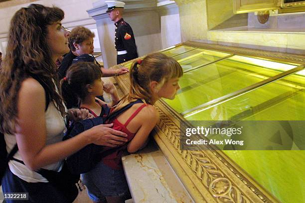 Visitors look at the original copies of the Declaration of Independence, the Constitution and the Bill of Rights July 4, 2001 at the National...