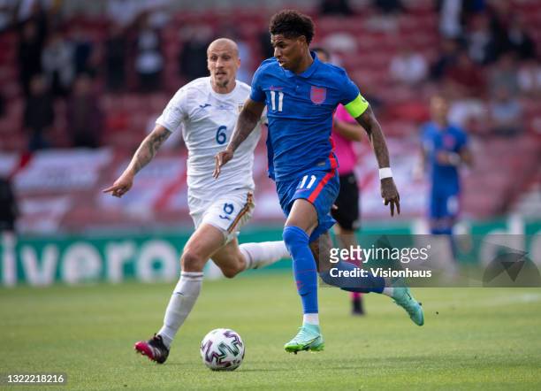 Marcus Rashford of England and Vlad Chiriches of Romania in action during the international friendly match between England and Romania at Riverside...