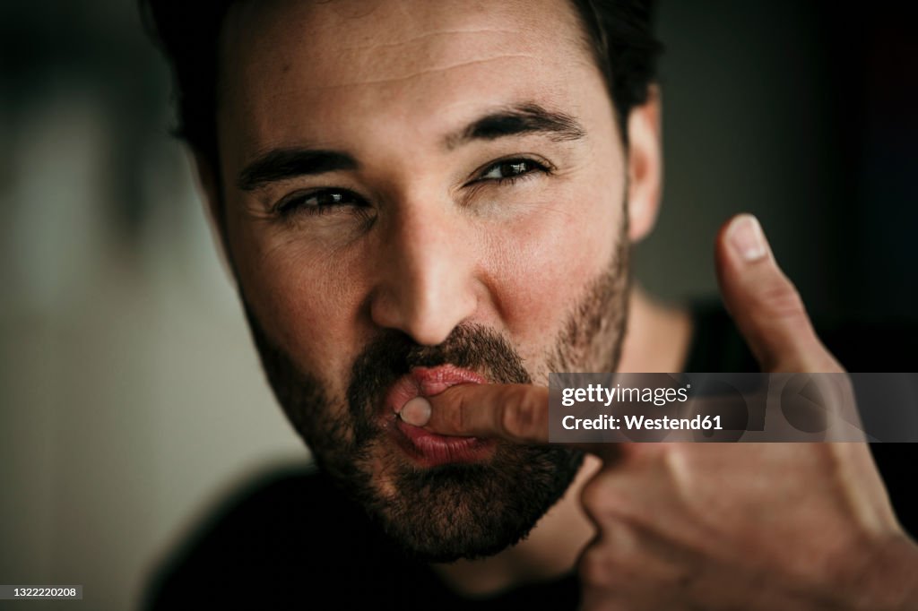 Man licking index finger
