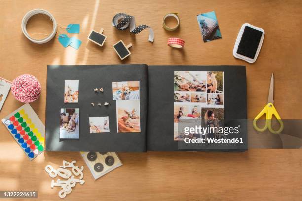 scrapbook of dog amidst craft utilities on table - diy top view stock pictures, royalty-free photos & images