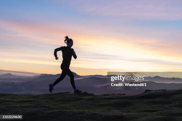 woman running on hill - cross country runner silhouette stock pictures, royalty-free photos & images