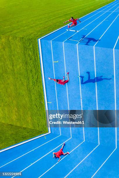 young man jumping over hurdle into abyss - athlete defeat stock pictures, royalty-free photos & images