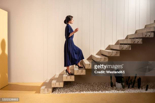 young woman moving up on staircase - 階段　のぼる ストックフォトと画像