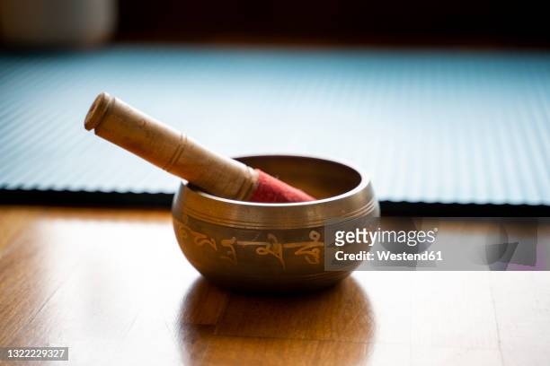 tibetan brass bowl on floor - buddhism stock pictures, royalty-free photos & images