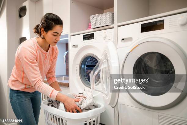 unloading the laundry - washing machine stock pictures, royalty-free photos & images