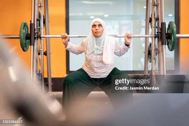 muslim woman workout with weights in gym - persian gulf stock pictures, royalty-free photos & images