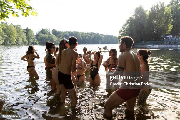 People relax and dance in the water at Schlachtensee lake in Zehlendorf district during the coronavirus pandemic on June 3, 2021 in Berlin, Germany....