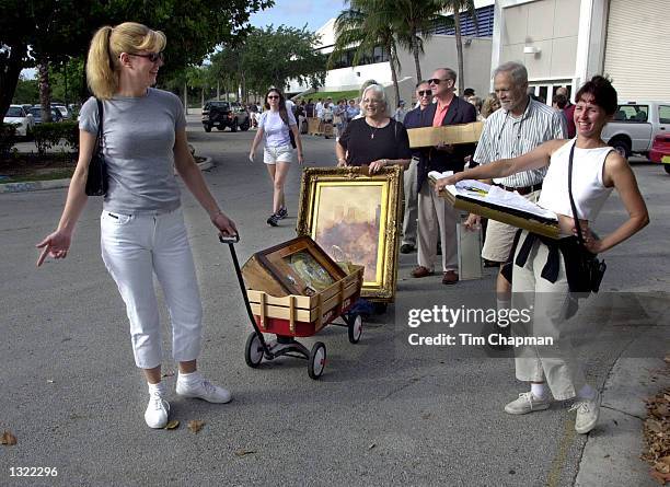 Sue Dale, left, pulls her son''s wagon with a penny arcade machine from the 1920''s era June 16, 2001 while she waits in line to get into Chubb''s...