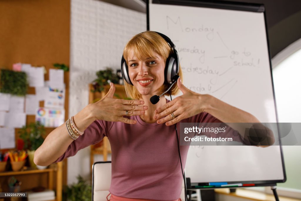 Teach In Sign Language Teacher Doing Sign Language During Video Conference High-Res Stock ...
