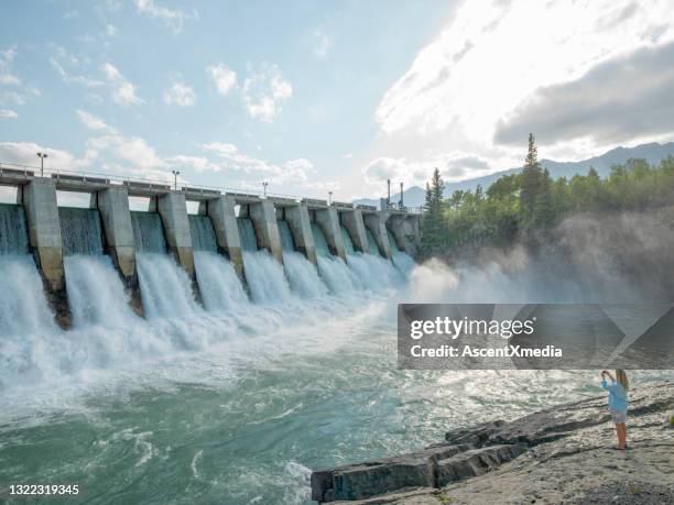 water rushes through hydroelectric dam - hydropower dam stock pictures, royalty-free photos & images