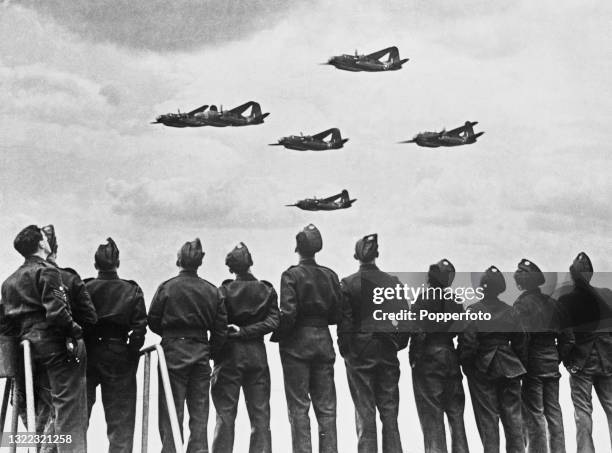 Montage image of aircrews from a Royal Air Force bomber command squadron turning out to watch a formation of RAF Douglas Boston Mk III light bombers...