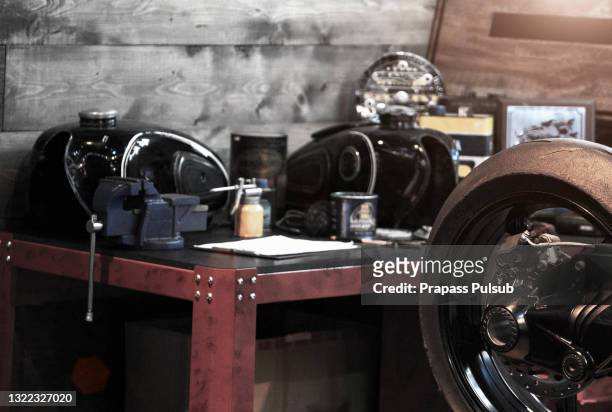 standing in dark repair shop - motorbike shop stock pictures, royalty-free photos & images