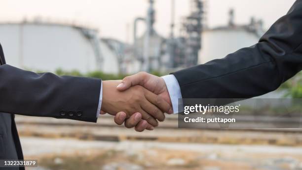 business people shaking hands, success business of refinery industrial, refinery business background concept image - contract manufacturing stock pictures, royalty-free photos & images