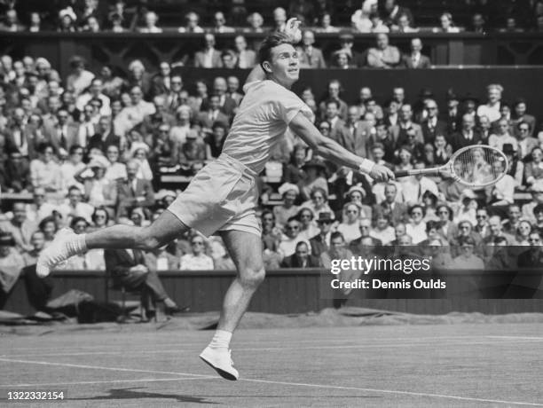 Ian Ayre of the Australia reaches to make a backhand return against compatriot Mervyn Rose during their Men's Singles First Round match on Centre...