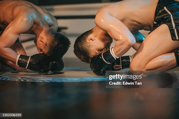 2 asian muay thai boxer bow to each other rivalry before the competition kick start praying ritual - muay thai stock pictures, royalty-free photos & images