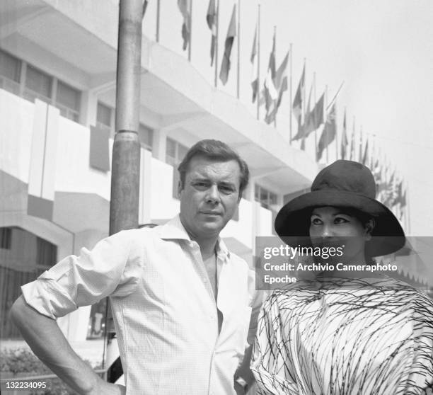 English actor Dirk Bogarde with Israeli actress Haya Harareet outside the Movie Festival palace, Lido, Venice 1967.