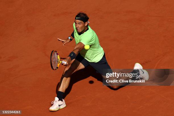 Rafael Nadal of Spain plays a backhand in their mens singles fourth round match against Jannik Sinner of Italy during day nine of the 2021 French...