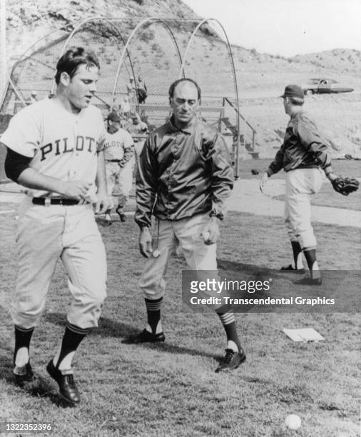 View of baseball coach Sal Maglie of the American League's Seattle Pilots, with an unidentified player during spring training, Tempe, Arizona, March...