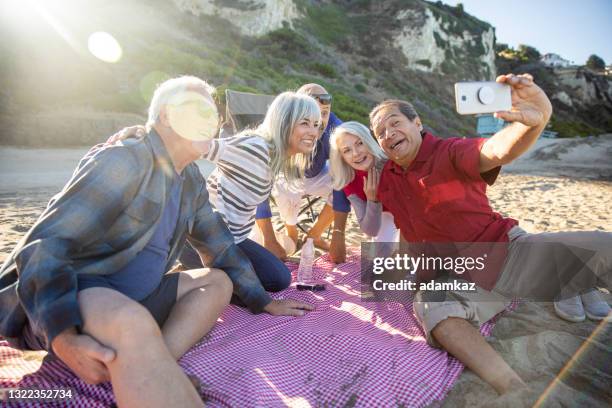 senior friends taking selfie at picnic - medicare advantage stock pictures, royalty-free photos & images