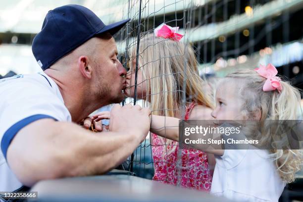 Kyle Seager of the Seattle Mariners kisses his daughter Audrey before the game against the Oakland Athletics during Lou Gehrig Day at T-Mobile Park...