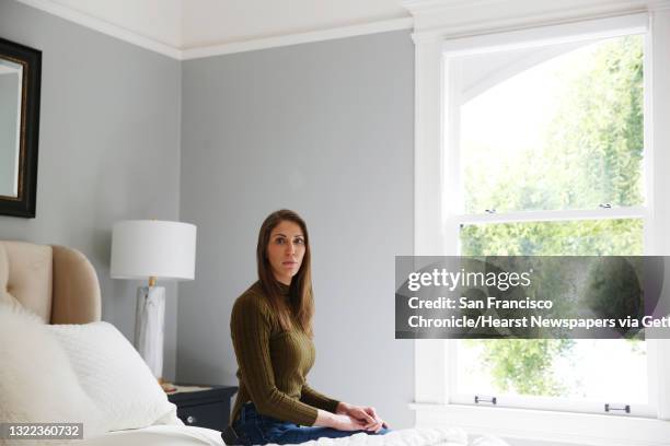 Nicole Steves sits for a portrait next to the window in her bedroom at her home on Wednesday, April 29, 2020 in San Francisco, CA. A man threw a rock...