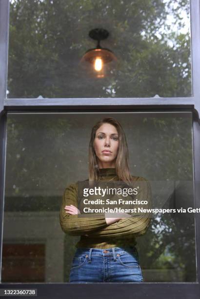 Nicole Steves stands for a portrait in a window in her bedroom at her home on Wednesday, April 29, 2020 in San Francisco, CA. A man threw a rock into...