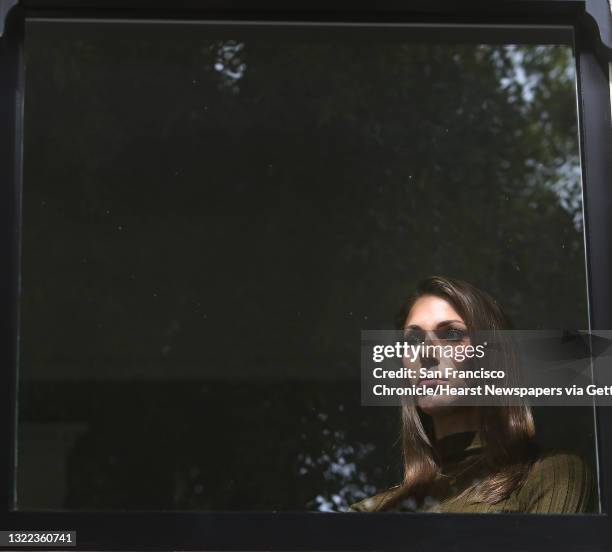 Nicole Steves stands for a portrait in a window in her bedroom at her home on Wednesday, April 29, 2020 in San Francisco, CA. A man threw a rock into...