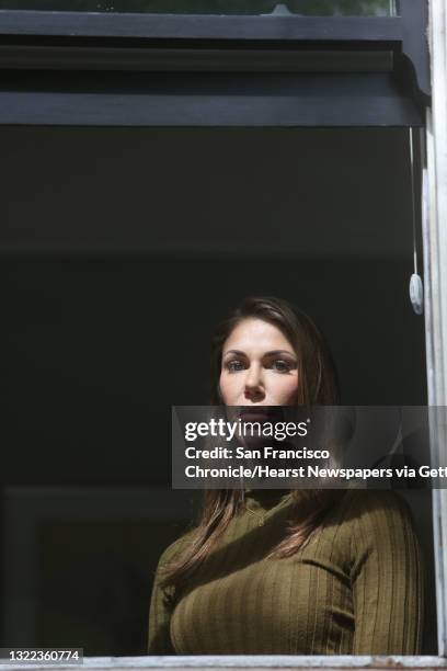 Nicole Steves stands for a portrait in a window in her bedroom at her home on Wednesday, April 29, 2020 in San Francisco, CA. A man threw a rock into...