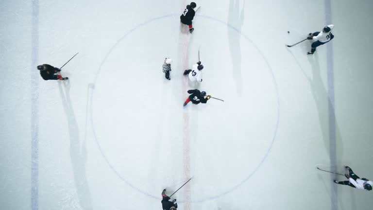 https://media.gettyimages.com/id/1322361192/video/top-view-ice-hockey-rink-arena-game-start-two-players-face-off-sticks-ready-referee-drops-the.jpg?b=1&s=640x640&k=20&c=ZVi5XvzhCSU8vcs-eOPVpnzQY58J7qVAJU6PSnM1Fos=