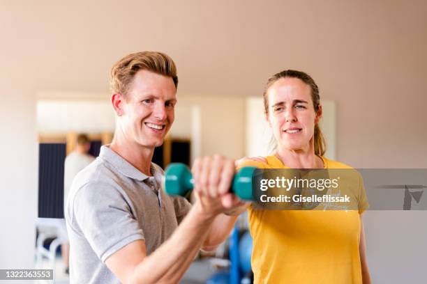 physiotherapist working with female patient in rehab - sport injury stock pictures, royalty-free photos & images