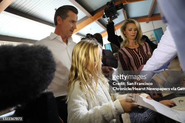 Lt. Governor Gavin Newsom gets help from his daughter Montana as she places his ballot in the counting machine on Tuesday, November 6, 2018 in...