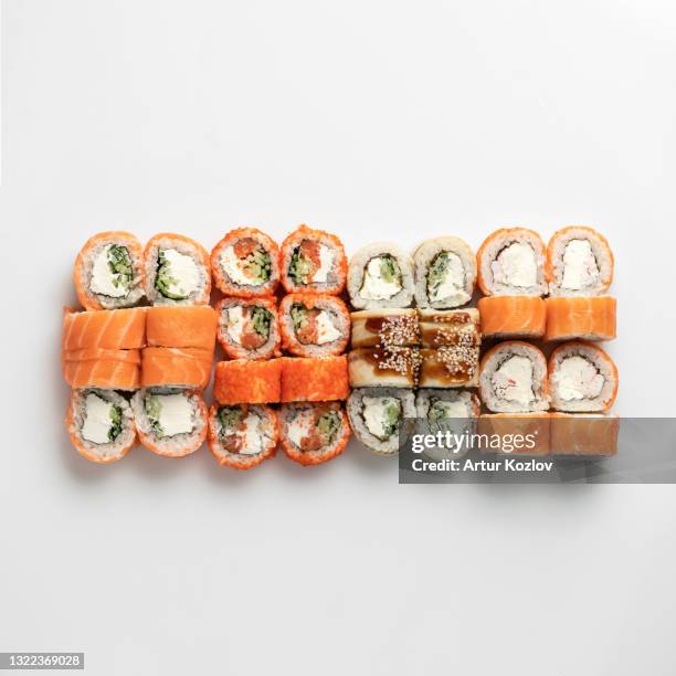 mixed sushi set isolated on white background. inside out rolls. traditional japanese food. healthy oriental meal. wellness concept. flat lay. top view. copy space - nigiri fotografías e imágenes de stock