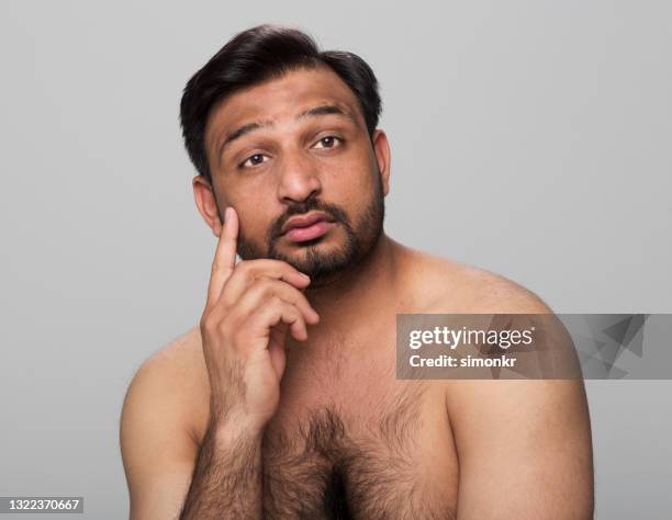 close-up of thoughtful young man - indian man shirtless stock pictures, royalty-free photos & images