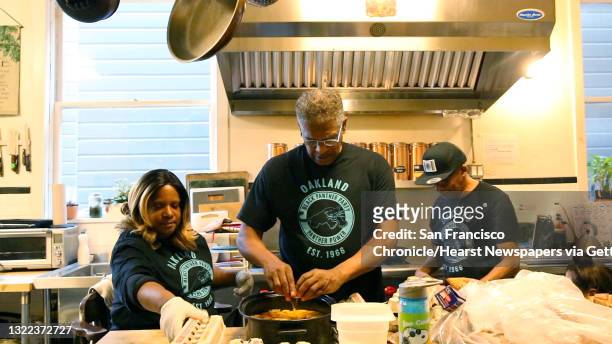Zafirah Ned, volunteer; &sp;Saturo Ned, volunteer and former Black Panther; and Bobby McCall, volunteer and former Black Panther, work in the kitchen...