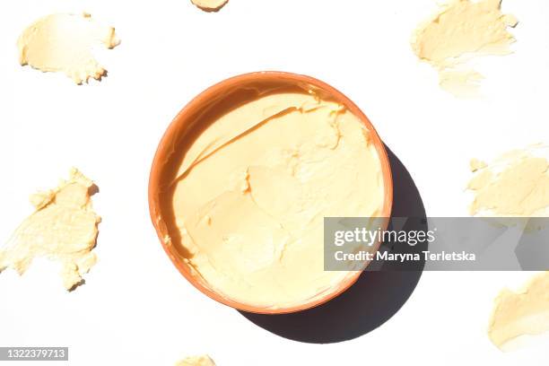 a jar of cream in beige with textured strokes. - texture mousse stock pictures, royalty-free photos & images