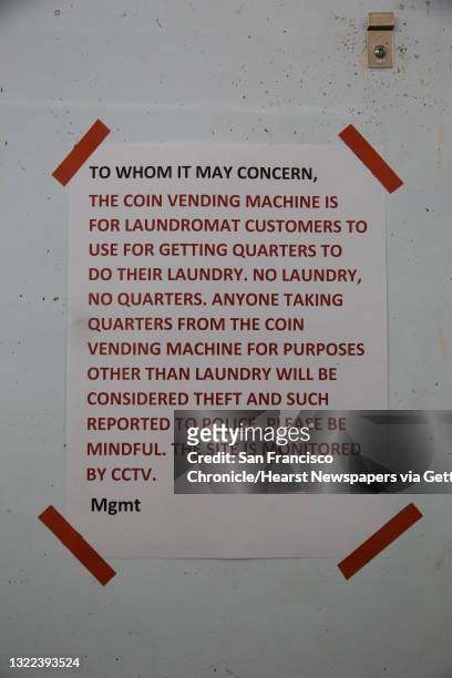 Sign at Super Wash Lavanderia informs people that the coin vending machine is only for laundromat customers doing their laundry at the laundromat and...