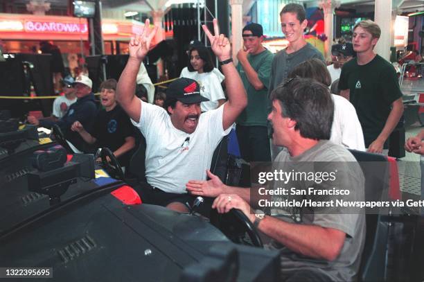 BOARDWALK 2/C/03AUG95/PZ/LS GUY ALBIN OF CAMPBELL CELEBRATES COMING IN FIRST PLACE ON THE DAYTONA USA GAME AT THE SANTA CRUZ BEACH BOARDWALK AS STEVE...