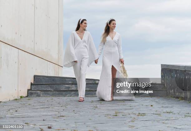 caucasian brides holding hands in a happy and smiling attitude. - civil partnership stock pictures, royalty-free photos & images