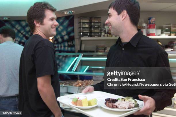 Eric Fredrickson, software engineer at Google, exchanges pleasantries with Larry Page, CEO and co-founder of Google, they get their lunch at the cafe...