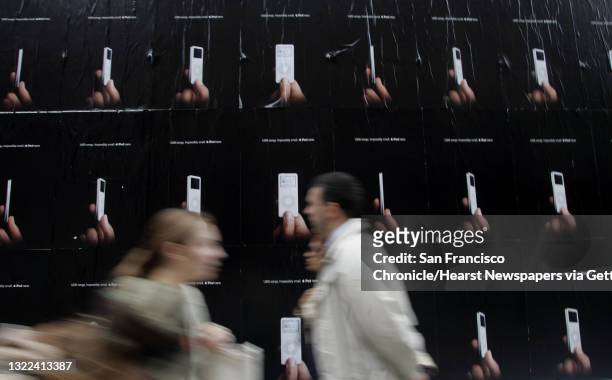Ipod079_ls.JPG Pedestrians walk past ads for the iPod Nano on Ellis St. Apple Computer Inc.'s new iPod Nano is creating a buzz, one that design...