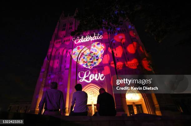 People look as the Washington National Cathedral is illuminated for Pride Month on June 07, 2021 in Washington, DC. The Cathedral will be lit in...