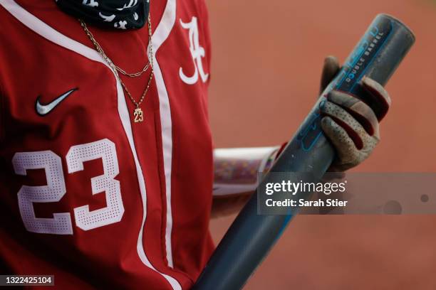 Detail of a necklace worn by infielder Savannah Woodard of the Alabama Crimson Tide during the fifth inning of Game 14 of the Women's College World...