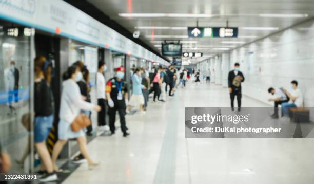 crowd of busy commuters with protective face mask walking in beijing subway - dukai photo beijing stock-fotos und bilder