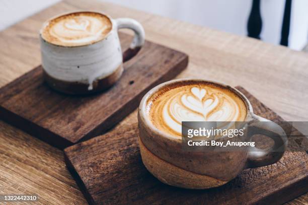 couple cup of latte coffee on wooden table. - coffee crop foto e immagini stock