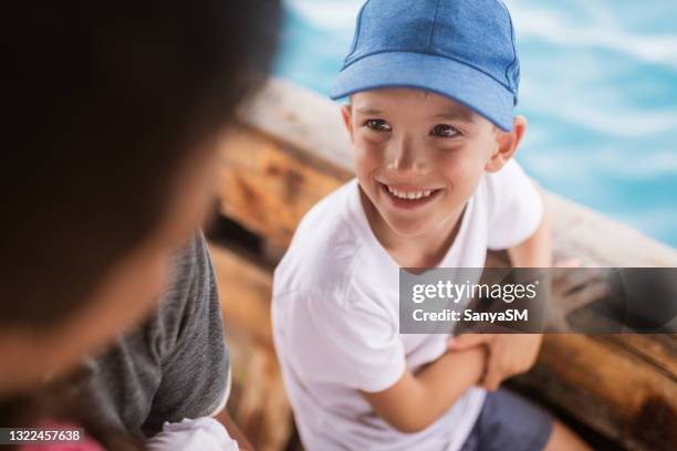 beautiful father and son enjoying boat ride - kid sailing imagens e fotografias de stock